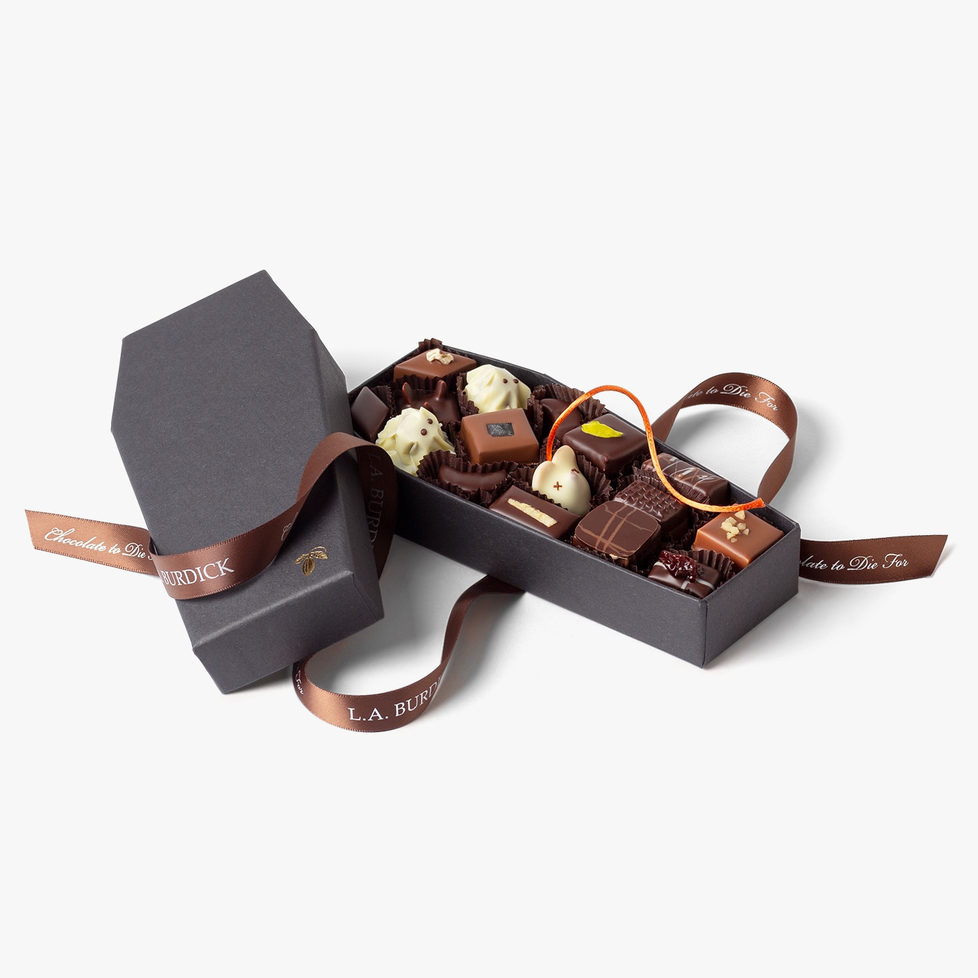 Chocolate ghosts and bonbons nestled in a coffin to celebrate Halloween